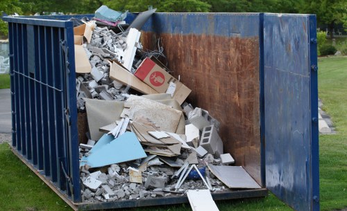 Investigator reviewing records and photographs related to skip hire and rubbish removal